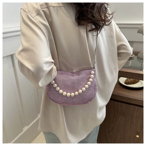Detail of purple rhinestone hobo bag with elegant pearl chain strap and sparkling crystals