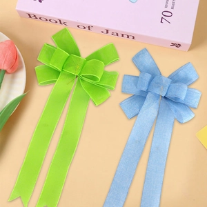 Linen texture bow hair clip with long tassels in blue and green for party hair styling