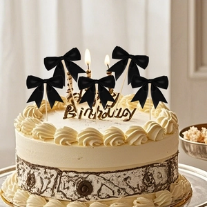 Set of 5 black ribbon bow cake toppers on white cream cake for birthday party decoration