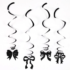 Detail of four black glitter bow hangers and PVC spiral swirls for party decorations