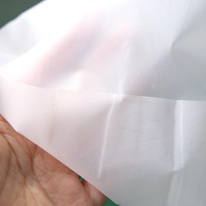 White 137x274cm disposable PE tablecloth with subtle square embossing for party decor
