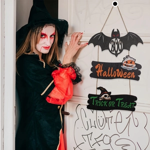 Halloween wooden sign featuring a black bat, orange pumpkin, and BOO text on a white door