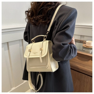 Close-up of ivory waterproof backpack with gold metallic closure and detailed stitching
