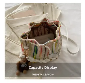 Internal view of colorful knitted bucket bag showing large capacity for smartphone