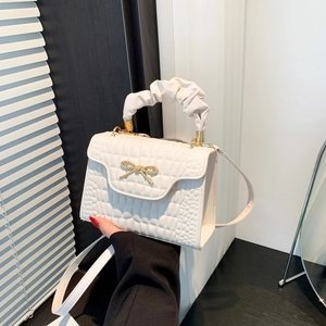 White crocodile pattern handbag with gold butterfly accent and pleated cloud handle