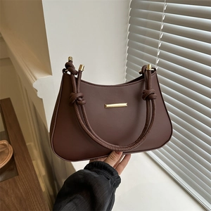 Premium dark brown leather shoulder bag with knotted handle and gold metal details