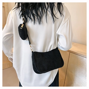 Détail du sac bandoulière en velours côtelé noir avec petite pochette et doré