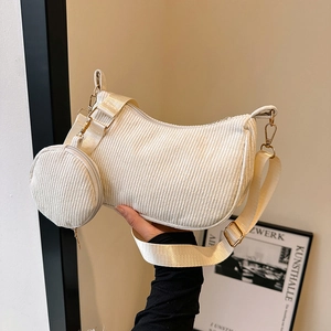 Beige corduroy crescent crossbody bag with matching round pouch and wide strap
