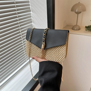 Fashionable straw crossbody bag with black faux leather flap and gold chain strap