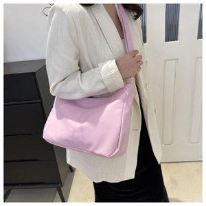 Pink PU leather hobo bag styled with a white blazer and black skirt for a chic spring look