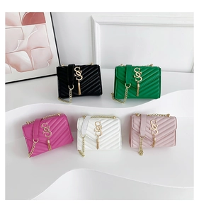 Detail of five quilted chain bags in various colors with elegant golden tassels