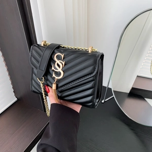 Elegant black V-quilted chain bag with golden SSS logo and stylish fringe tassel detail