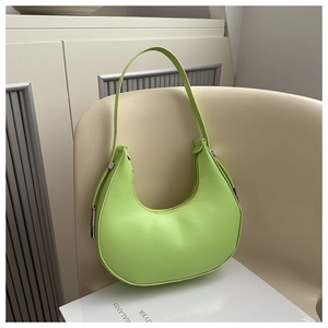 Detailed view of a lime green saddle bag on a chair for summer styling and fashion