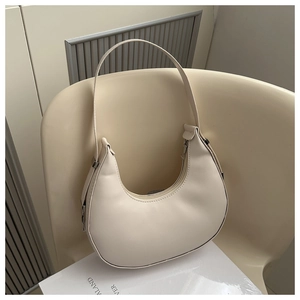 Minimalist creamy white leather saddle bag with smooth finish and silver zipper detail