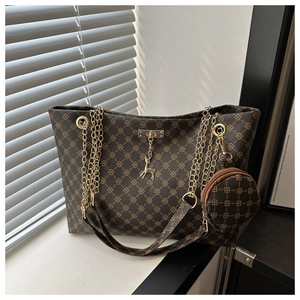Detail of vintage tote bag with geometric print, gold chain straps and a small coin purse