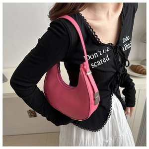 Detail of pink hobo shoulder bag showing smooth leather texture and adjustable strap