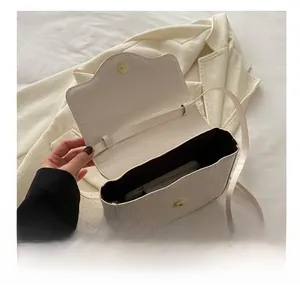 Internal capacity of white crocodile pattern bag showing space for a smartphone