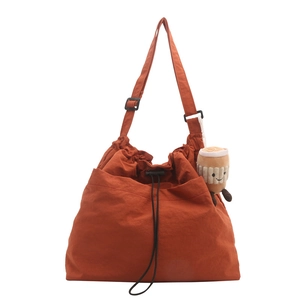Burnt orange large capacity nylon tote bag with drawstring and plush cup charm