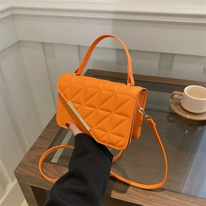 Chic orange quilted crossbody bag with golden metal hardware and top handle for women