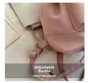 Detail of adjustable pink nylon strap with silver metal buckle on modern backpack