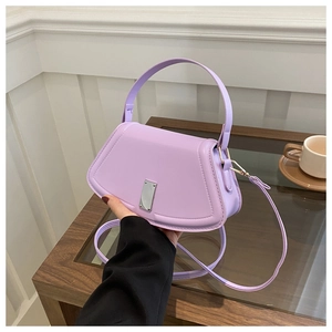 Close-up of a lilac leather crossbody bag featuring a silver rectangular metal clasp