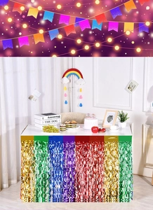 Rainbow fringe table skirt detail made of iridescent foil for birthday party decoration