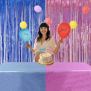 Gender reveal party decorations with laser foil curtains and boy or girl balloons