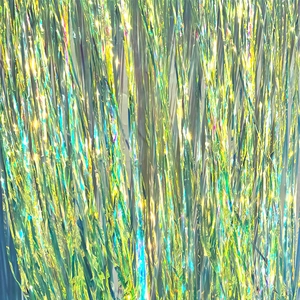 Close-up of iridescent laser fringe curtain with vibrant blue and gold metallic reflections