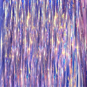 Close-up of iridescent purple laser foil fringe curtain with shimmering star effects