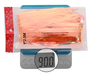 Detailed view of peach-pink foil fringe curtain 1x2.5M on digital scale weighing 90g