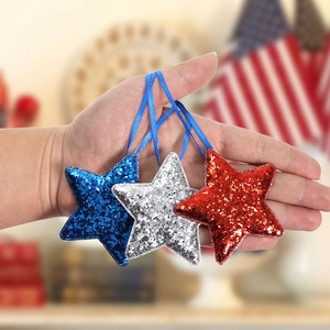 Independence Day star ornaments in red silver and blue sequins with blue hanging ribbons