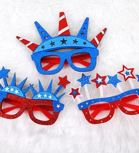 Close-up of glitter Independence Day party glasses with red white and blue star designs