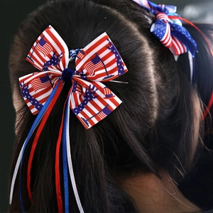 Detail of Independence Day bow hair ties with stars, stripes and long ribbons on hair