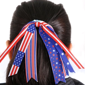 Back view of a model wearing the American flag style multi-layer ribbon bow on black hair