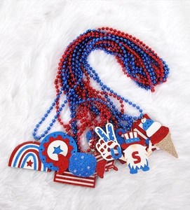 Detail of Fourth of July beaded necklaces with red and blue sequin star and rainbow charms