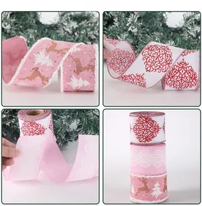 Detail of Christmas ribbons with pink elk patterns and white lace edges on festive decor