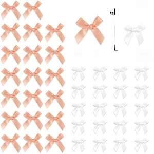 Detailed grid of 40 mixed size pink and white satin bows with dimension markings