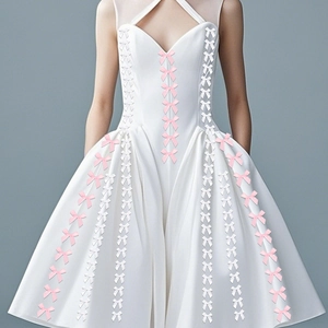 Detail of small handmade ribbon bows decoration on white satin dress with halter neck