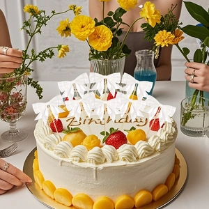 Detailed view of white satin ribbon bow toppers on a fruit birthday cake for party decor