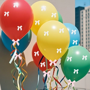 Close-up of colorful balloons decorated with small satin bows and curly ribbons for parties