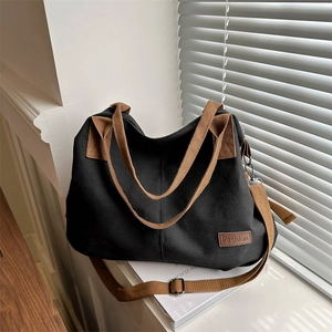 Black and brown canvas bucket tote bag with adjustable strap for commuting