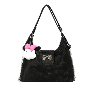 Minimalist black hobo shoulder bag featuring silver bow buckle and plush charm detail