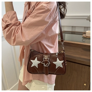 Detail of brown faux leather shoulder bag with white stars and contrast stitching