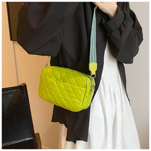 Quilted lime green crossbody bag with a decorative green and white wide strap