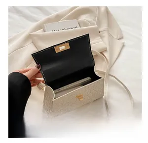 Detail of woven square bag interior showing capacity to hold a smartphone easily