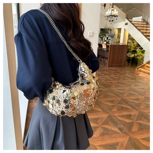 Detail of crescent sequin bag with gold and silver metallic discs and silver chain strap