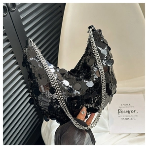 Fashionable black sequin hobo bag with silver chain strap shown in a hand-held view
