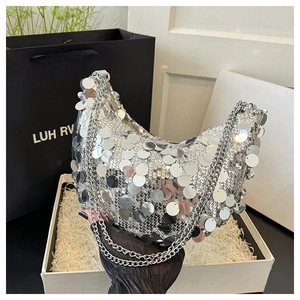 Detailed view of silver sequin hobo bag with thick metallic chain strap in gift box