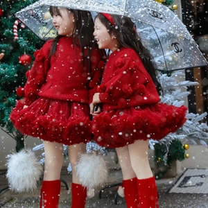 Detail of red knit sweater with 3D pom-poms and matching mesh tutu skirt for Christmas