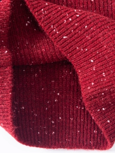 Close-up of dark red ribbed knit fabric with white tweed speckles for high warmth